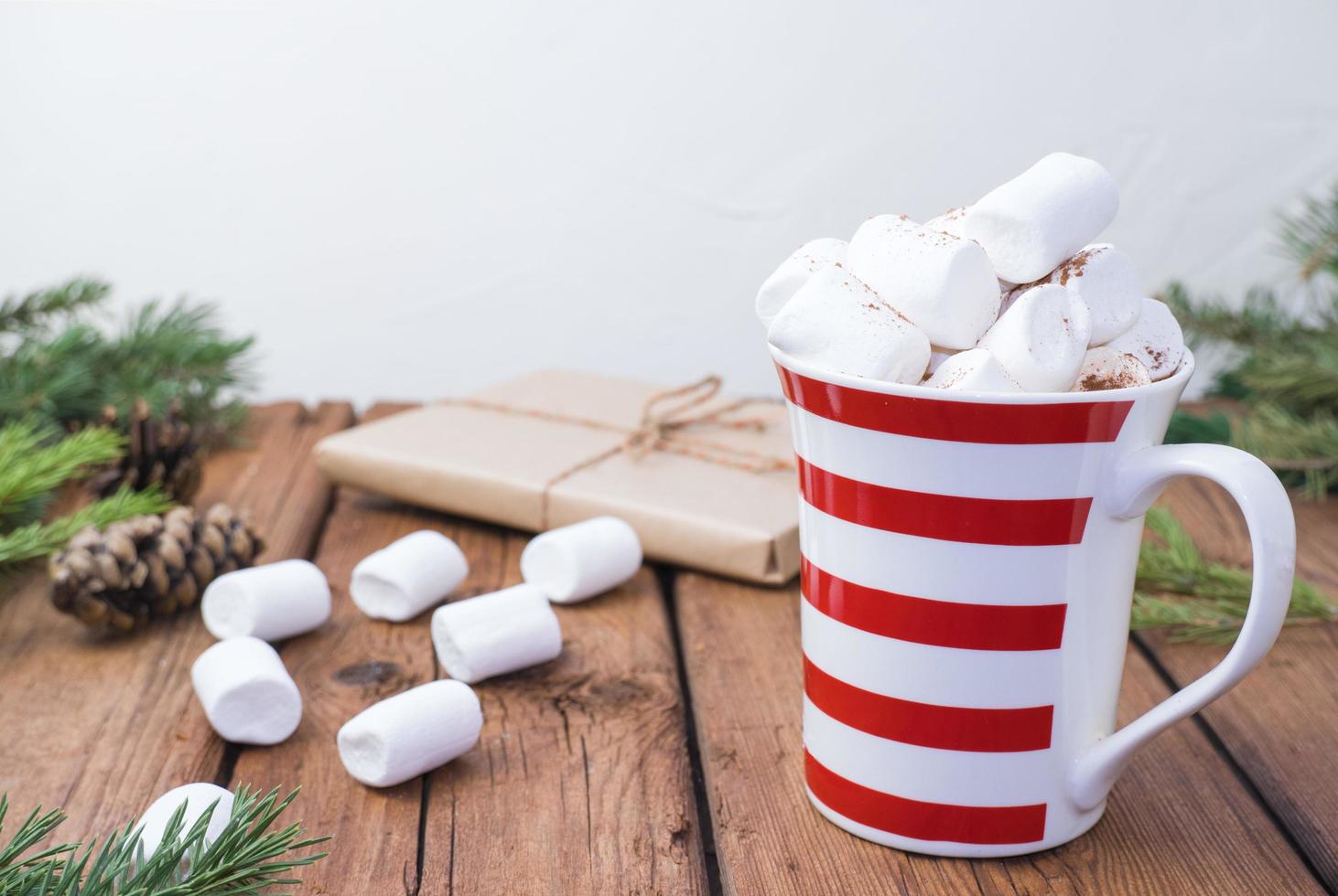 sweet hot cocoa with marshmallows, winter christmas drink on wooden background. photo