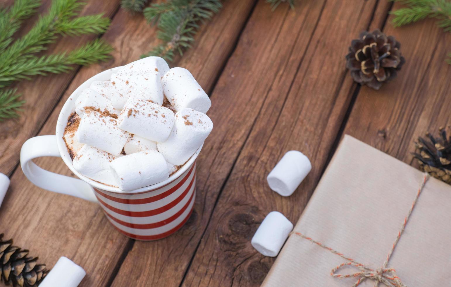 sweet hot cocoa with marshmallows, winter christmas drink on wooden background. photo