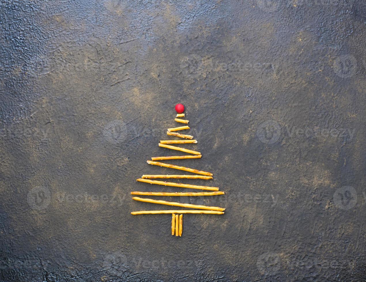 Christmas tree made of cookies, on a black texture background. photo