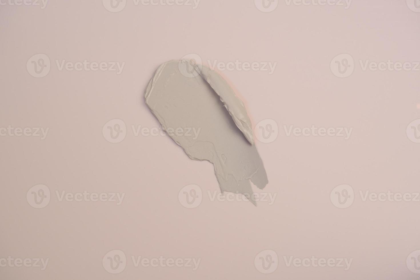 Pink cream base texture background. A smear of cream on a beige background. photo