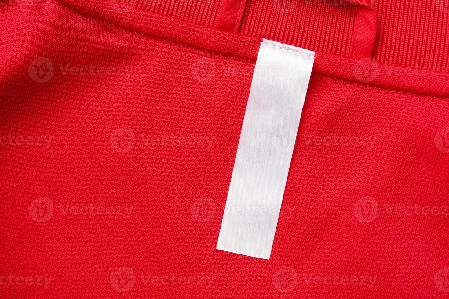 White blank clothes label on red jersey texture background photo