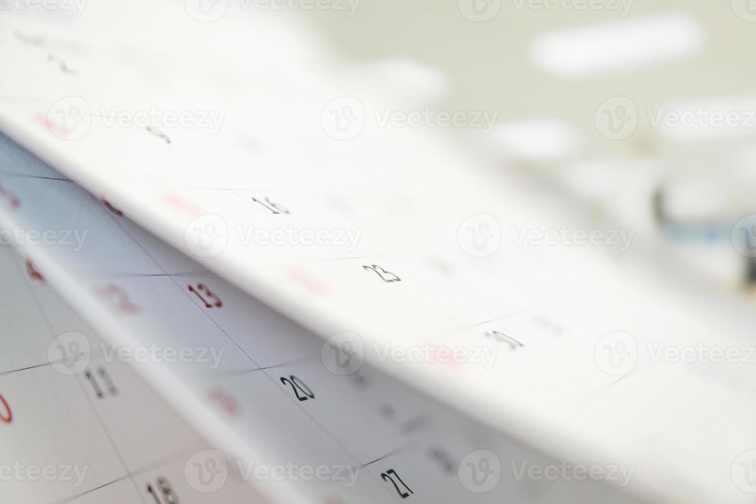 Calendar page flipping sheet close up on office table interior background business schedule planning appointment meeting concept photo