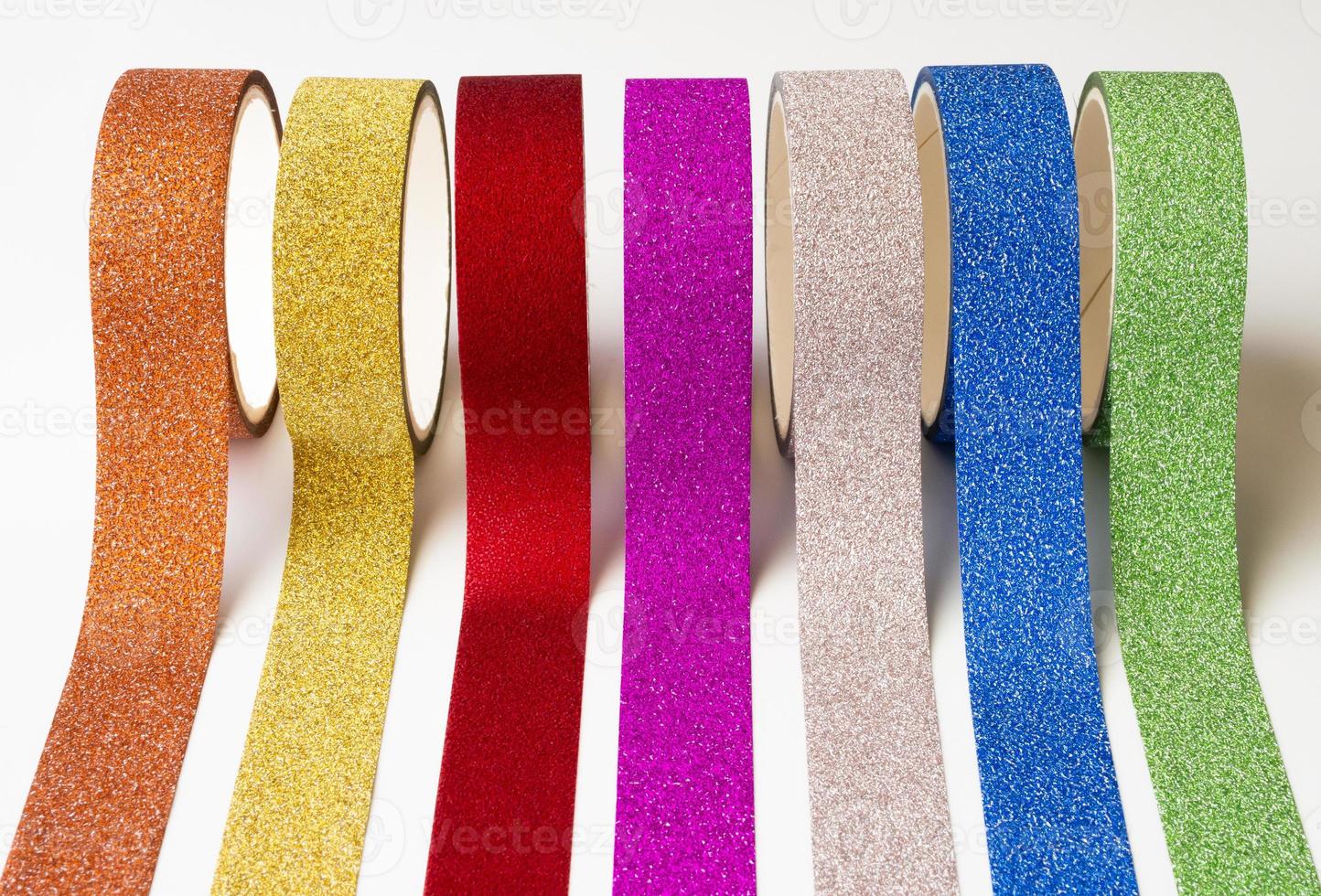 colorful glitter tape rolls strips on white background photo