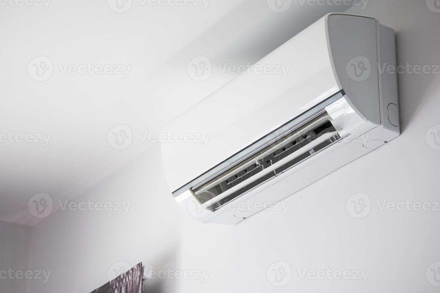 Air conditioner on white wall room interior background photo
