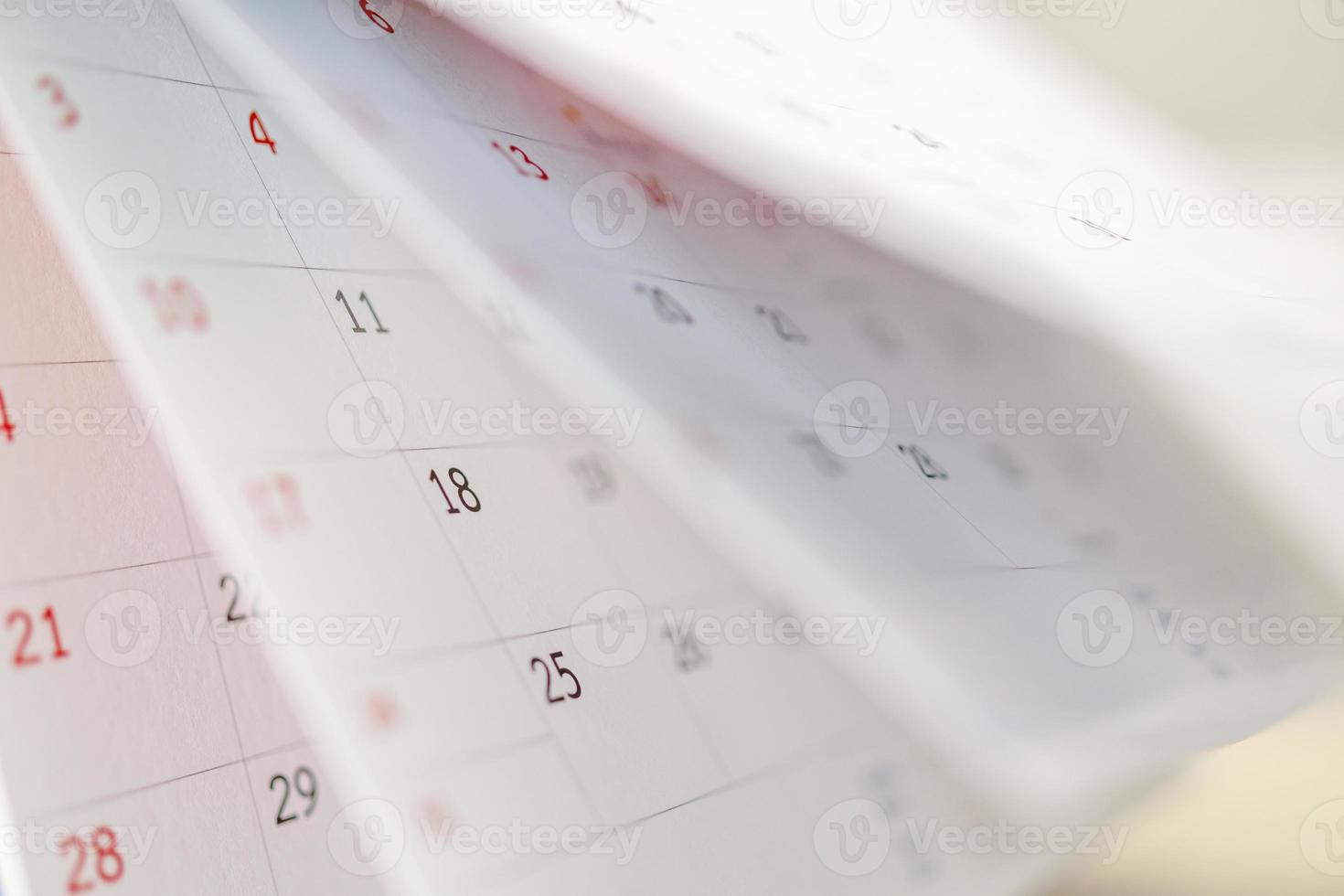 Calendar page flipping sheet close up on office table background business schedule planning appointment meeting concept photo