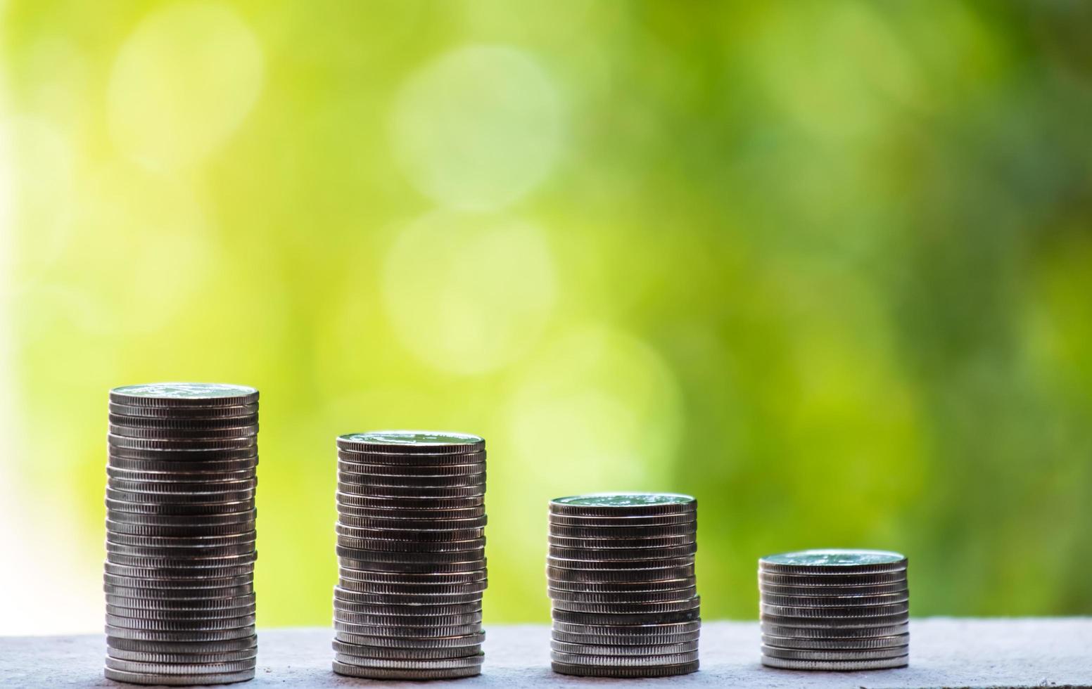 Business Finance and Money concept, Money coin stack growing graph with green tree bokeh background,investment concept photo