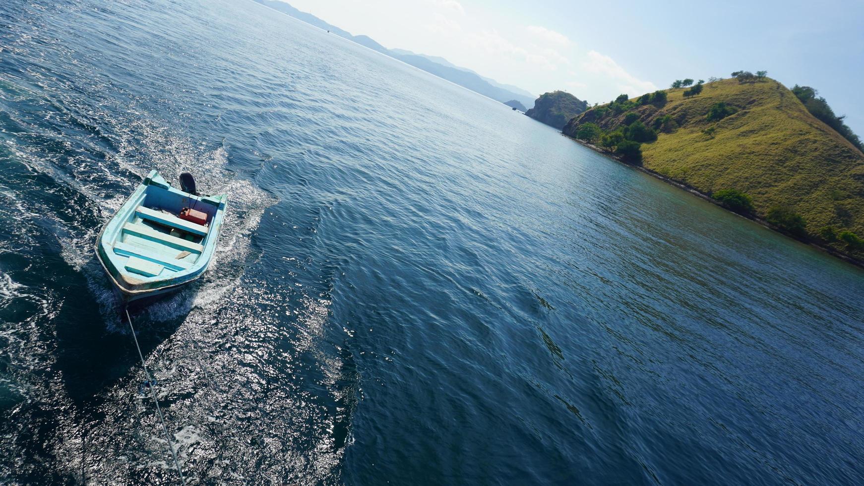 Boat tagged behind sail boat photo