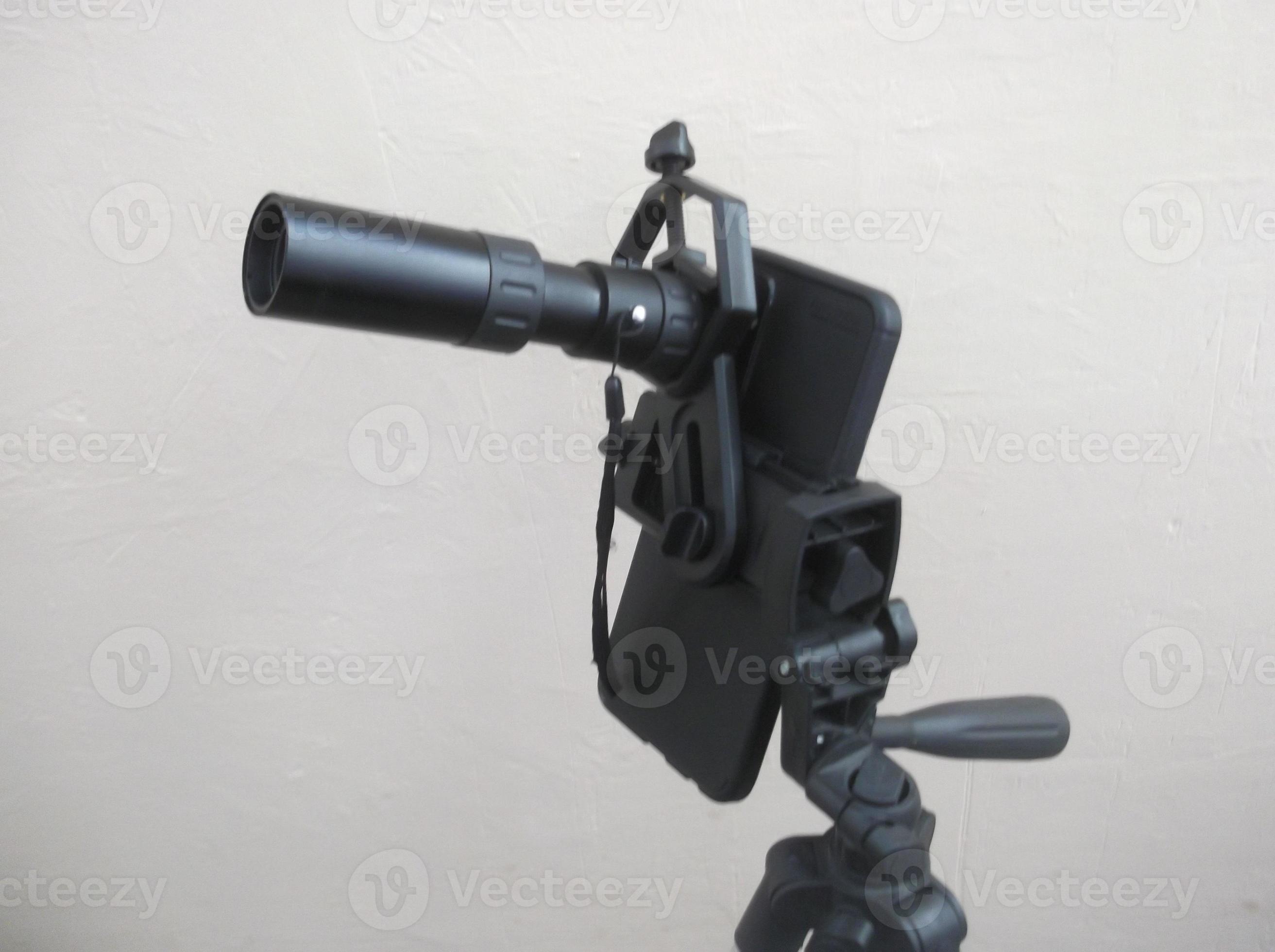 Attachment between monocular telescope and smartphone on a tripod