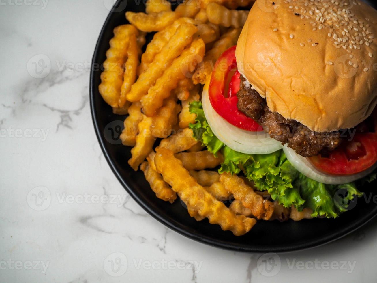 Homemade pork hamburger with fresh lettuce, tomato, fried egg, fresh onion photo