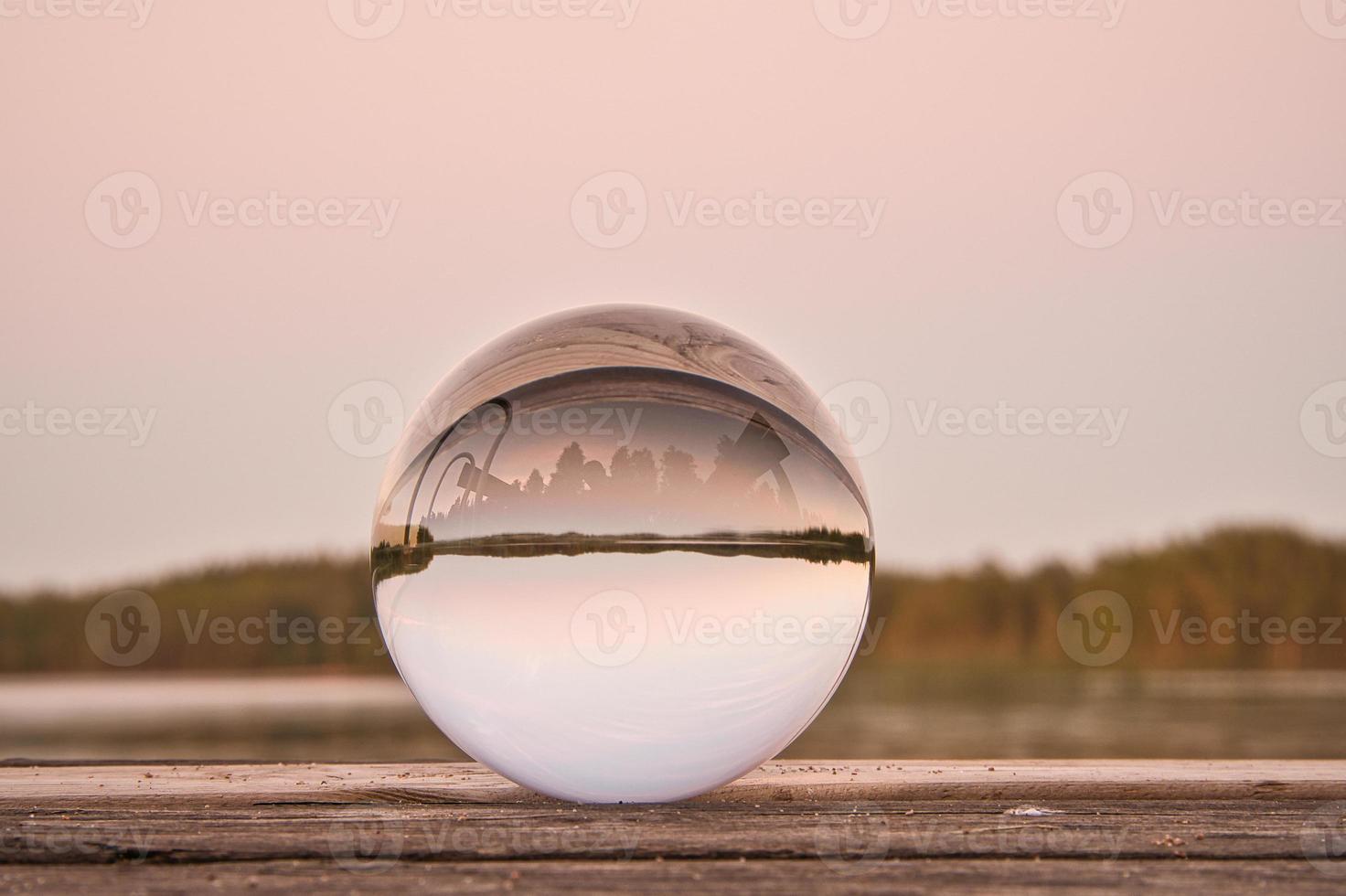 Glass ball on a wooden pier at a Swedish lake at evening hour. Nature Scandinavia photo