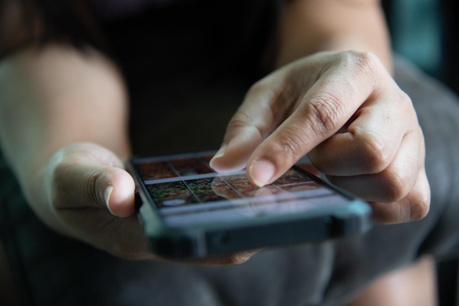 hand woman choosing pictures on smart phone. photo