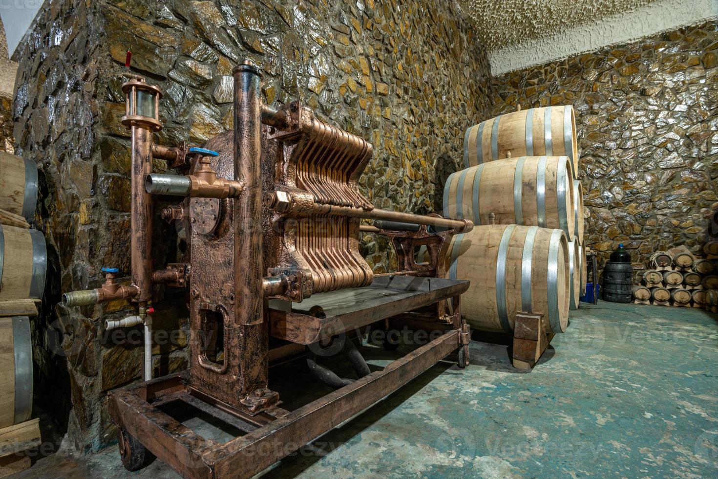 The wooden wine barrels in a wine factory photo