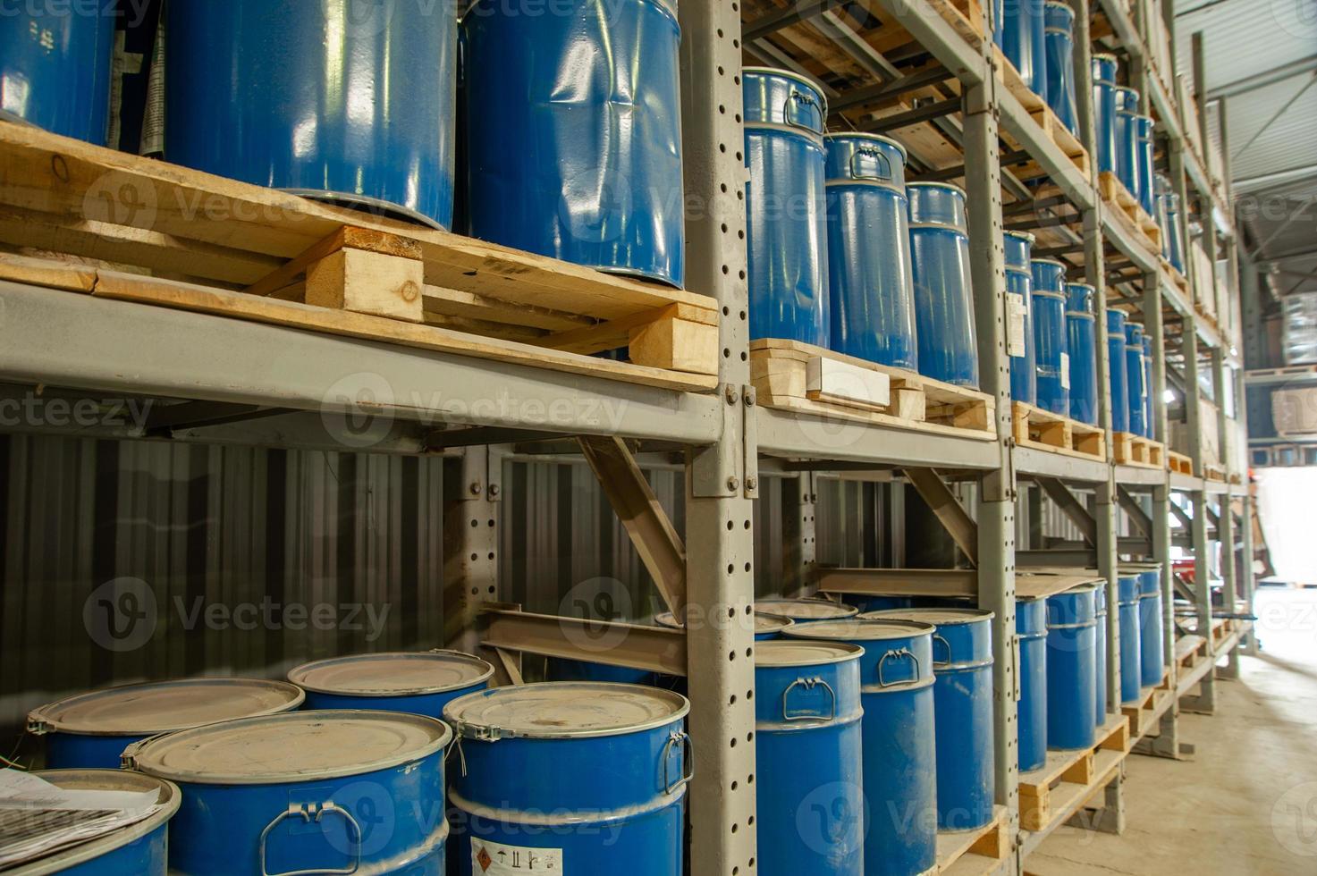 A warehouse with blue industrial metal barrels photo