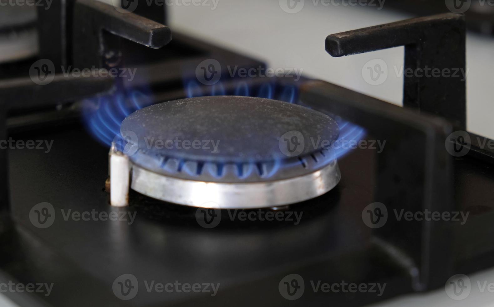 Close-up blue flames of fire on a gas burner in the kitchen for cooking. Gas flame in a gas boiler photo