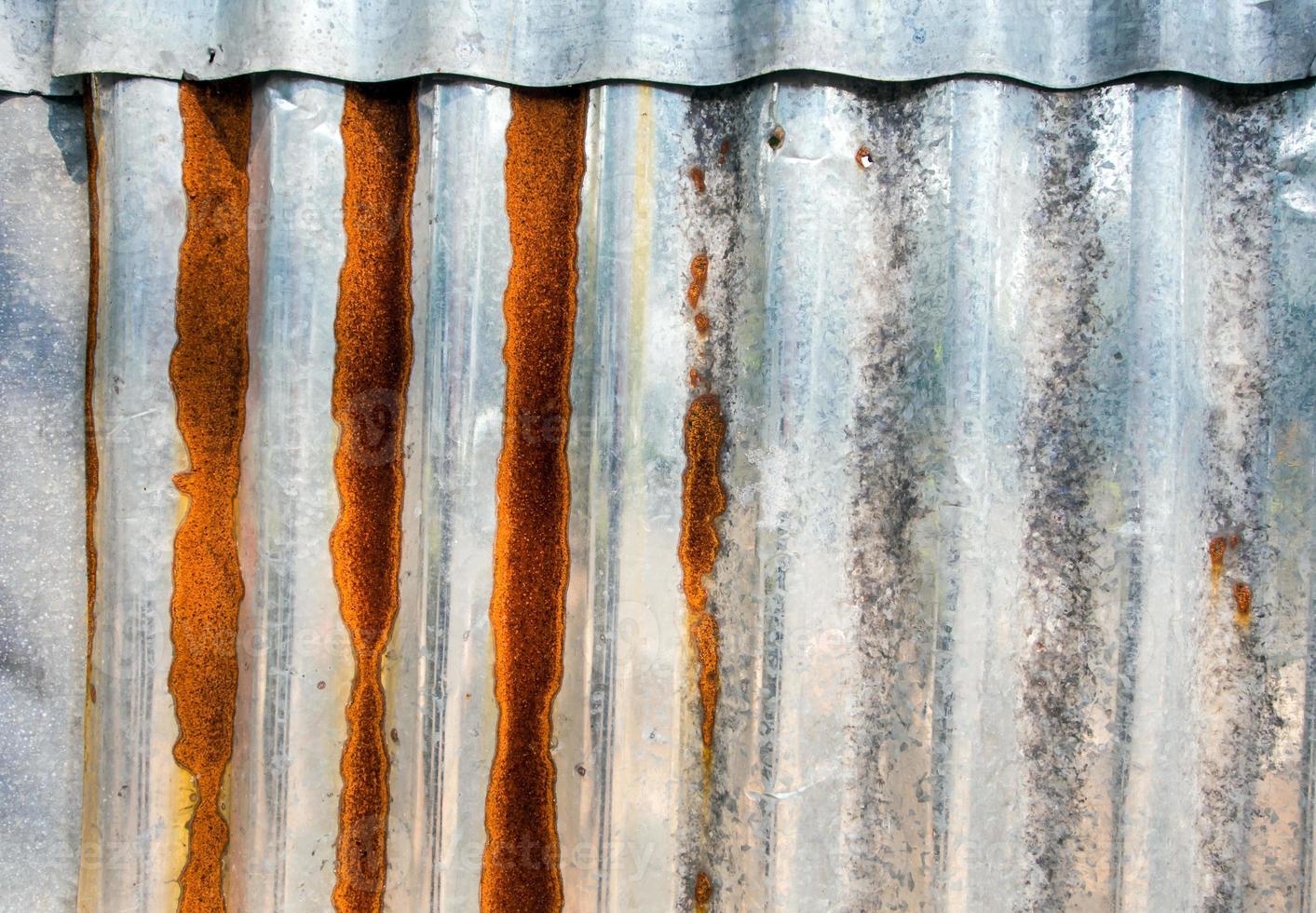 Rusty corrugated galvanized sheet iron fence photo