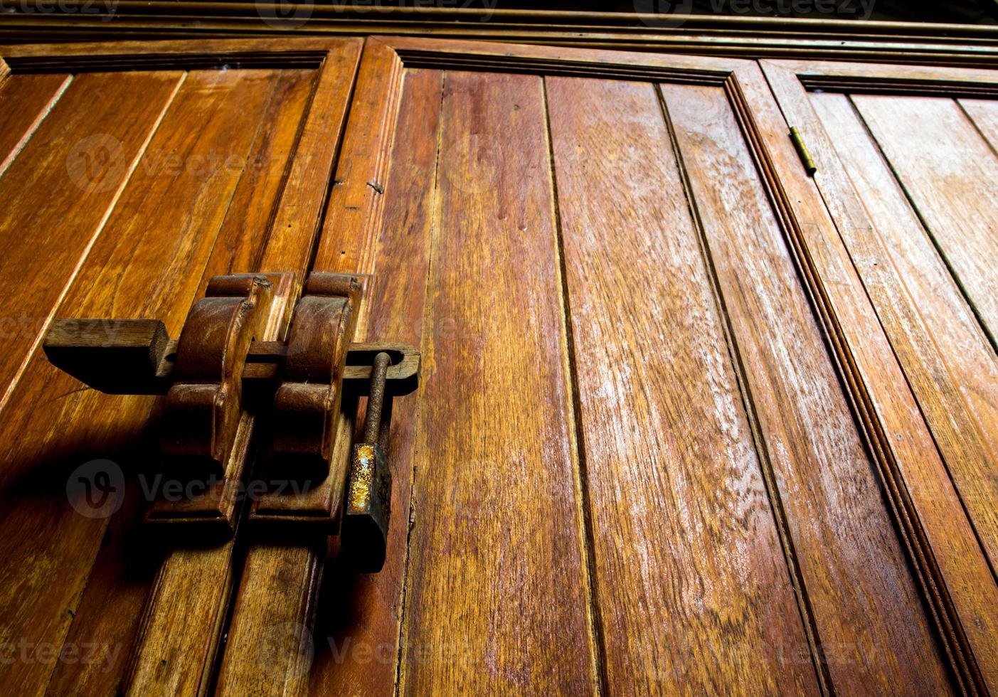 Wooden cabinet and lock at the door handle photo