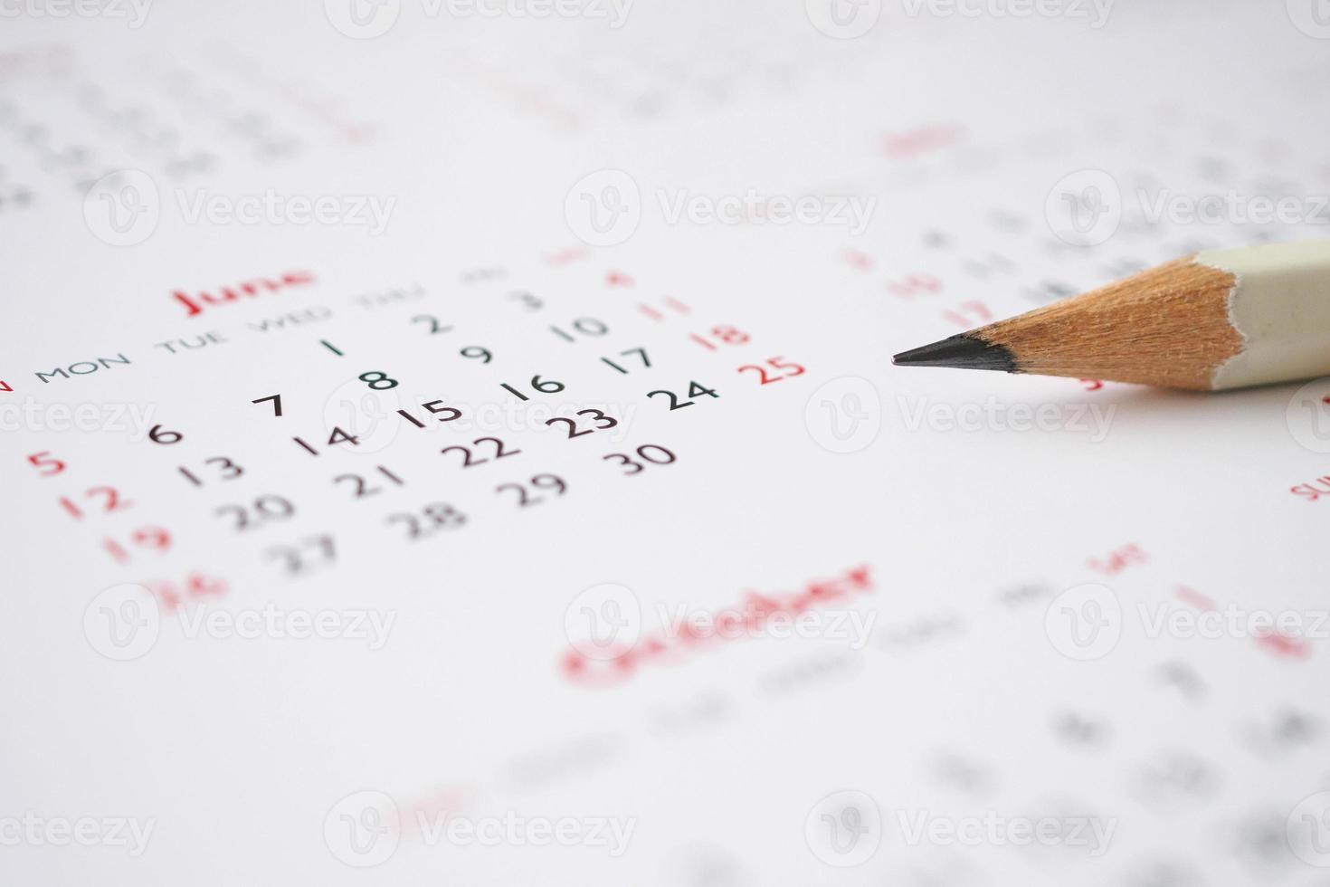 white pencil on calendar background business planning appointment meeting concept photo