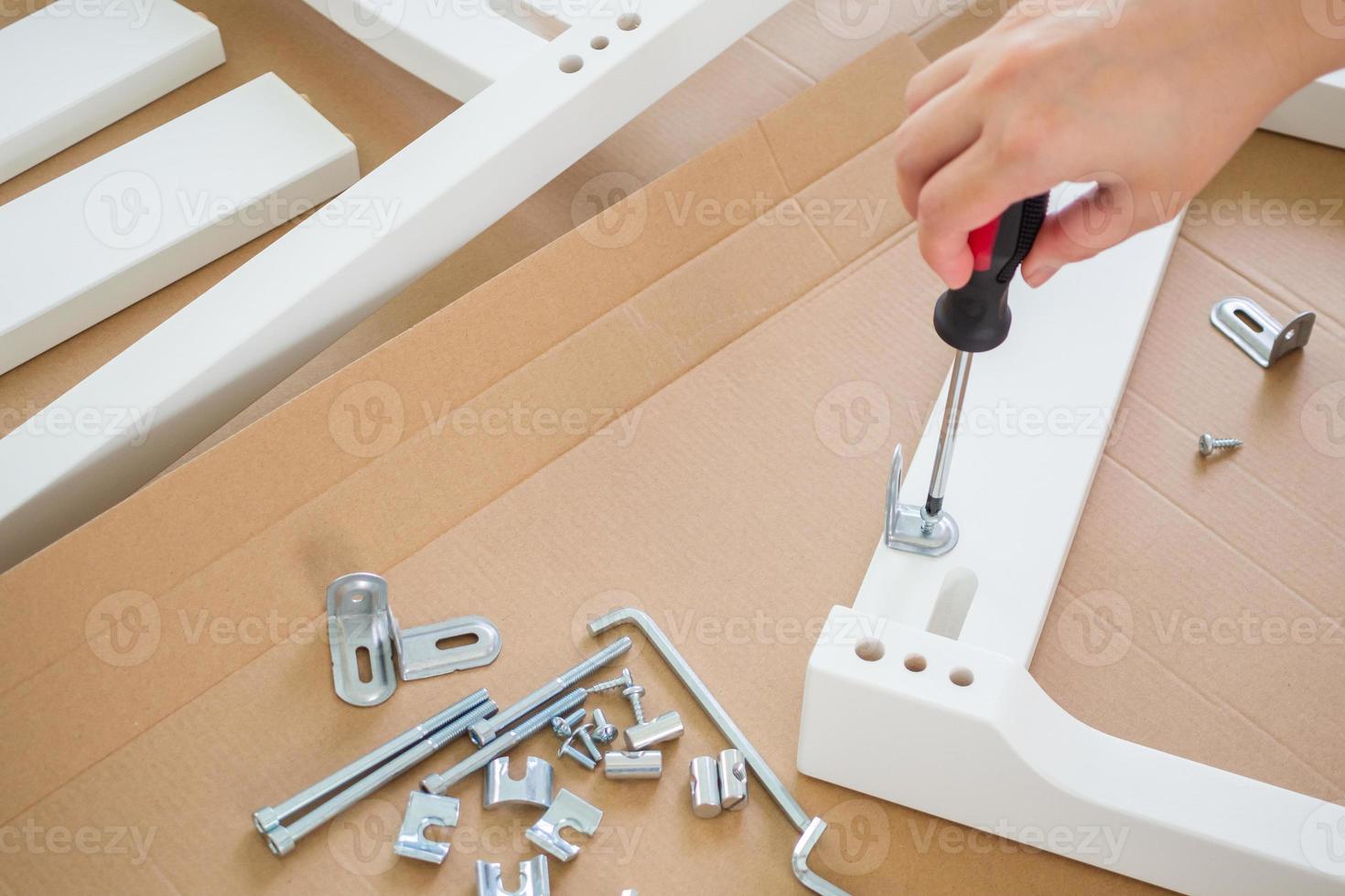 Assembly furniture using screwdriver at home photo