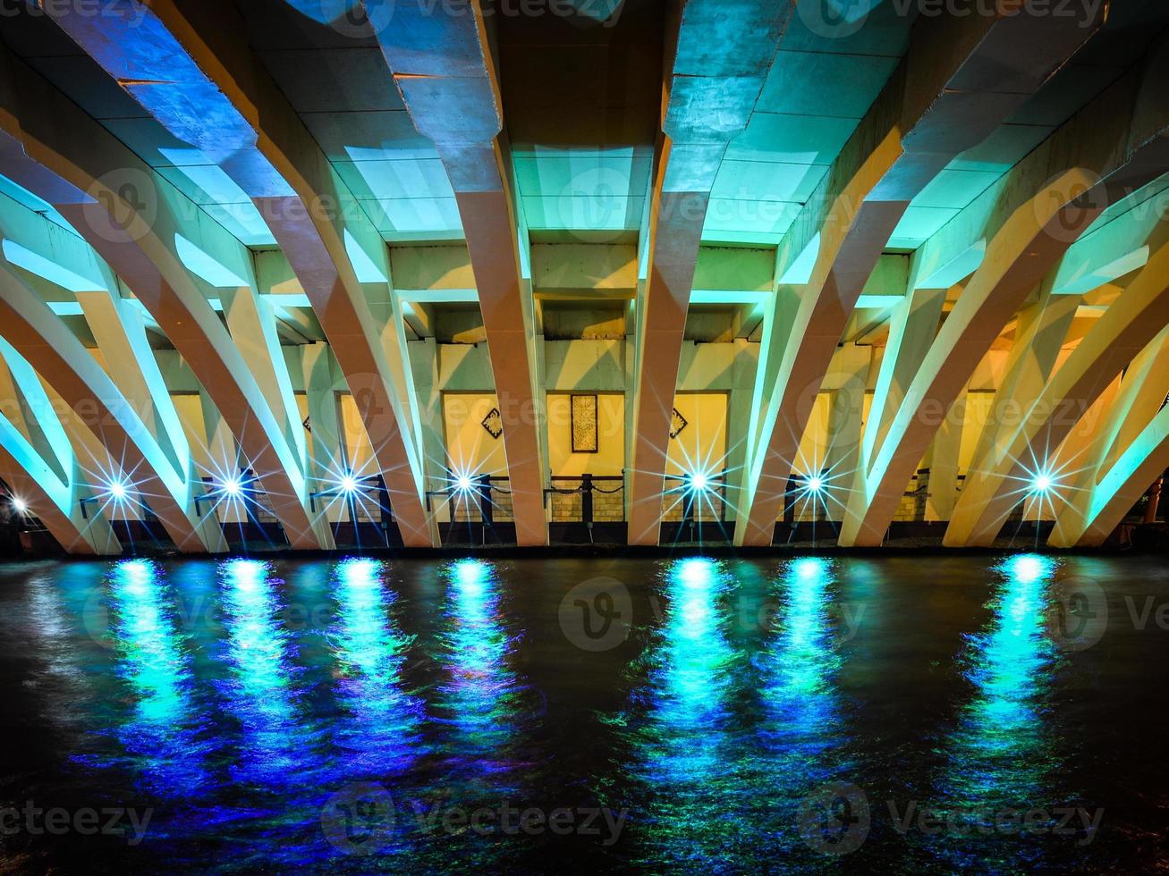 Night view of an illuminated concrete bridge in Melaka, Malaysia photo