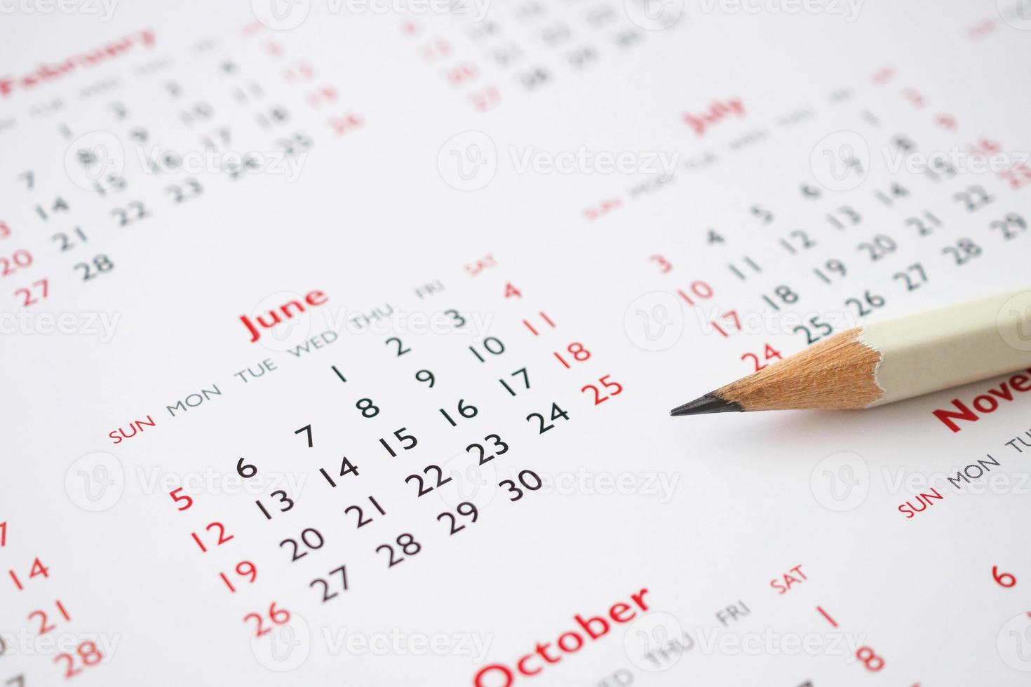 white pencil on calendar background business planning appointment meeting concept photo