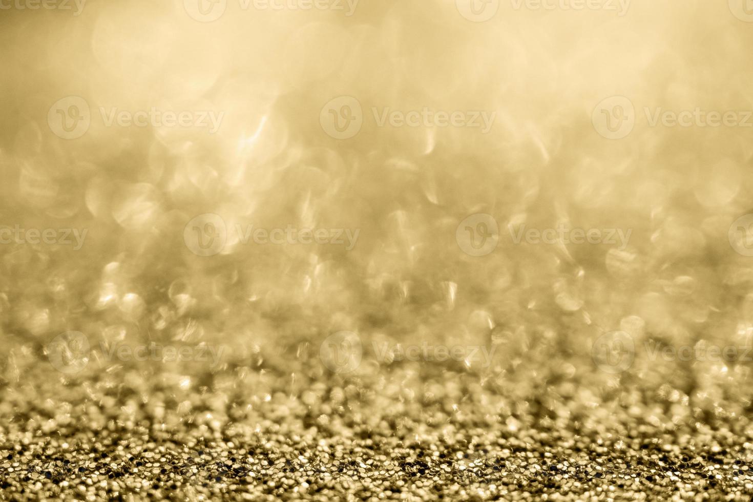 Abstract gold glitter sparkle blurred with bokeh background photo