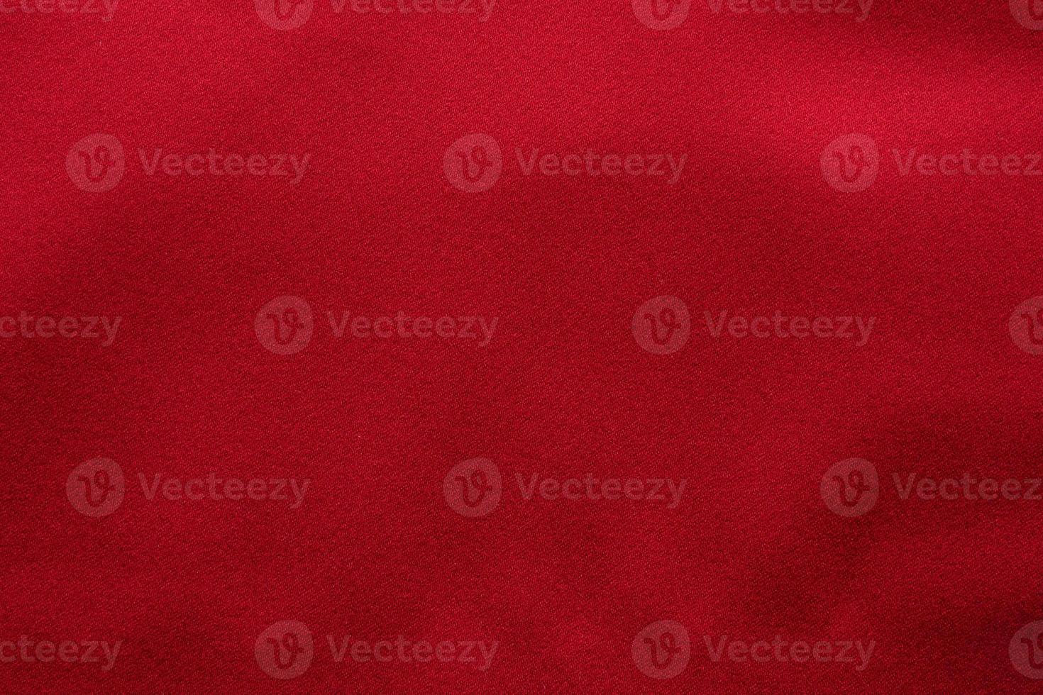Red fabric texture background close up photo