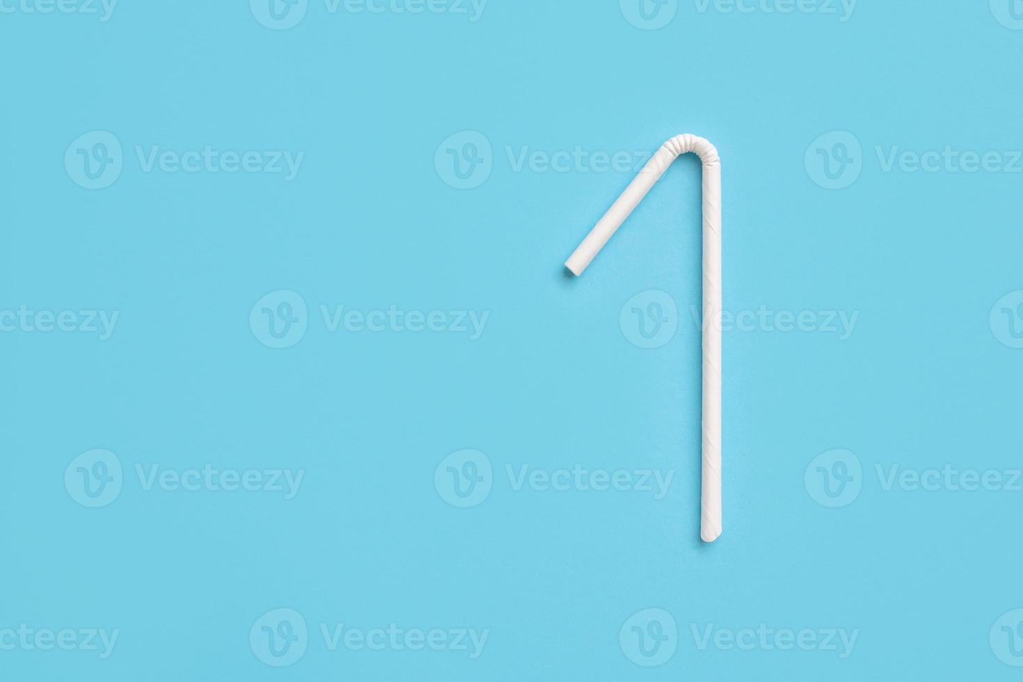 Biodegradable eco friendly white paper drinking straw on blue background photo