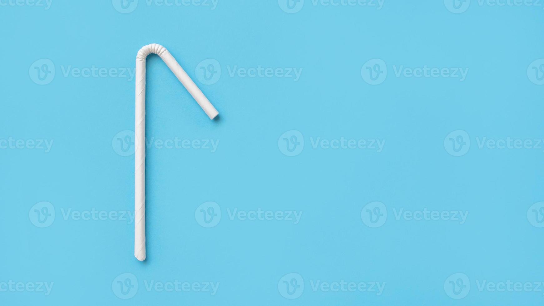 Biodegradable eco friendly white paper drinking straw on blue background photo