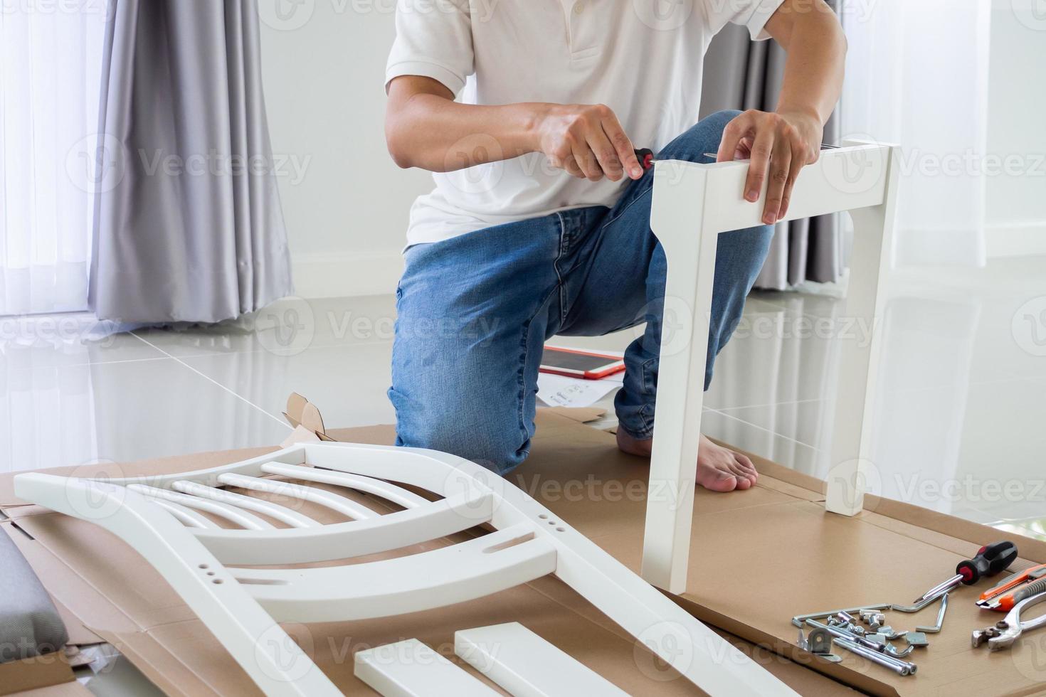 Assembly furniture using screwdriver at home photo