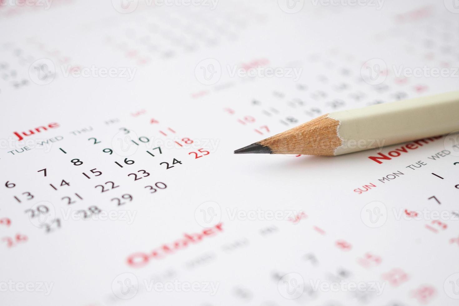 white pencil on calendar background business planning appointment meeting concept photo