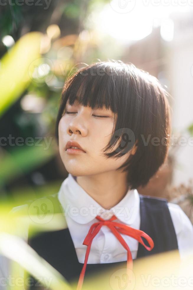 Portrait of young adult woman in japanese student uniform at outdoor on day photo