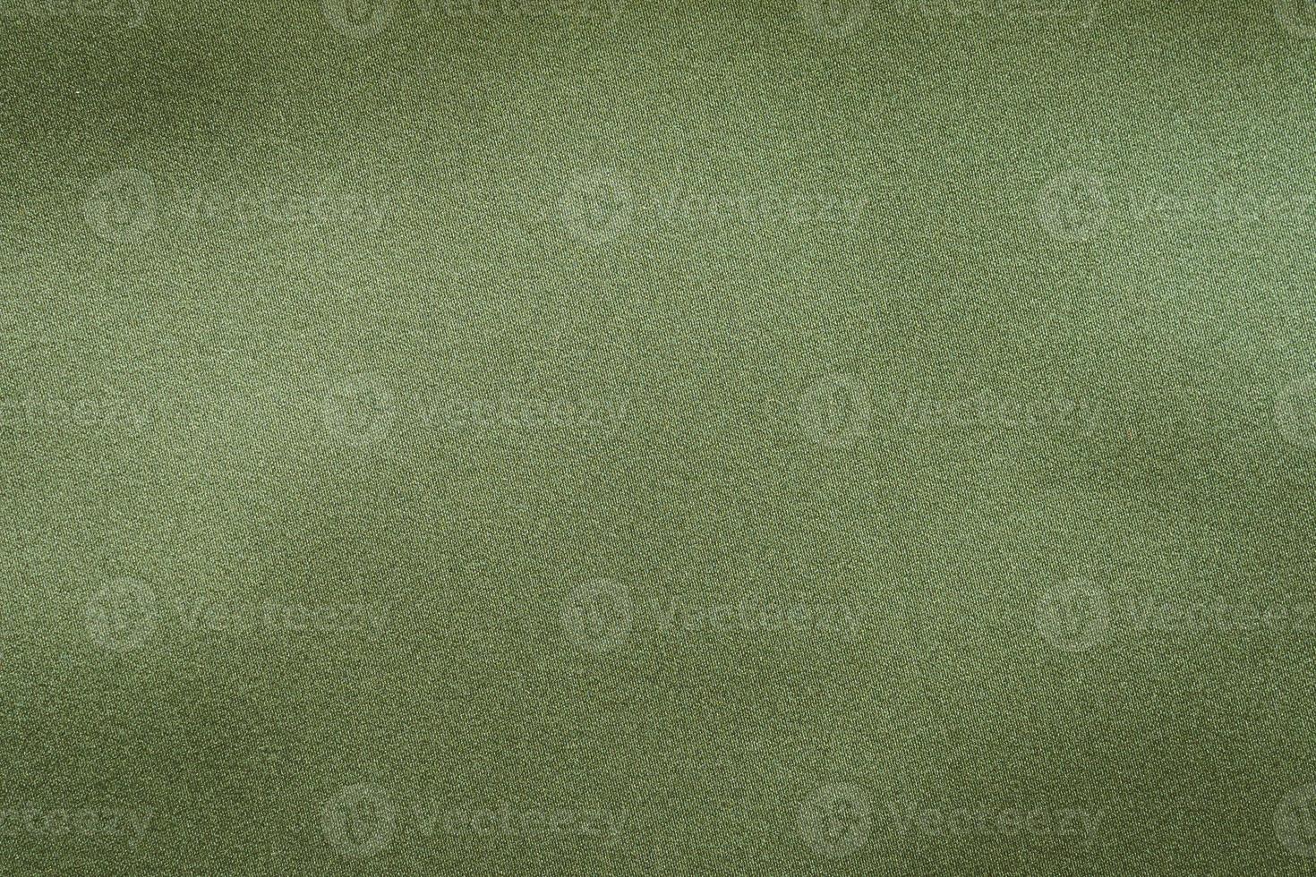 Green fabric texture background close up photo