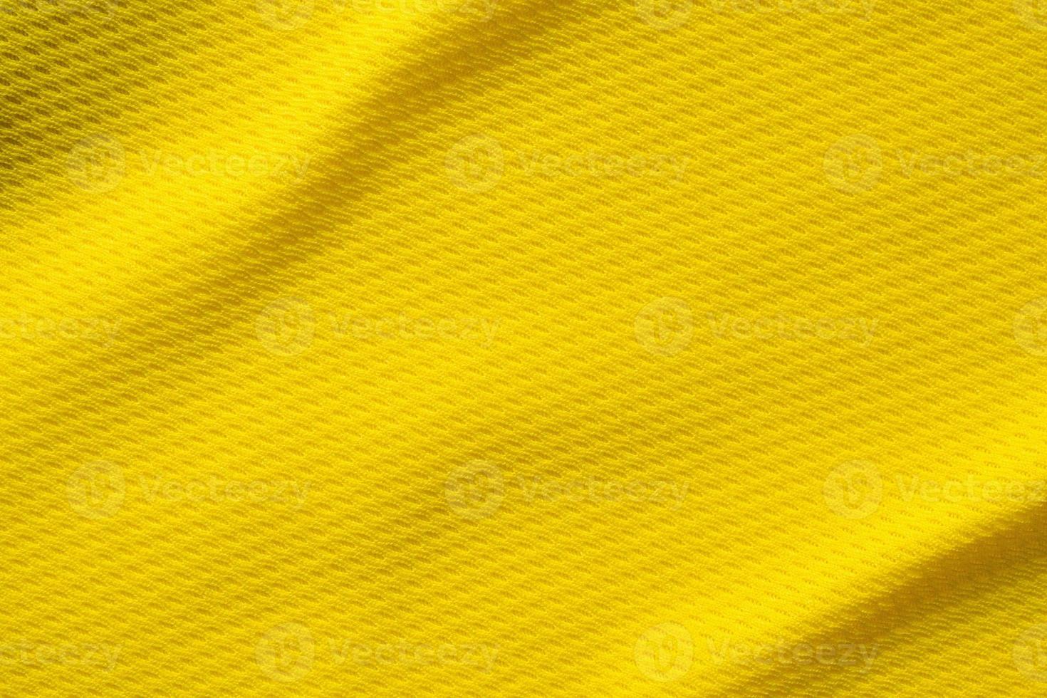 Yellow sports clothing fabric football shirt jersey texture close up photo