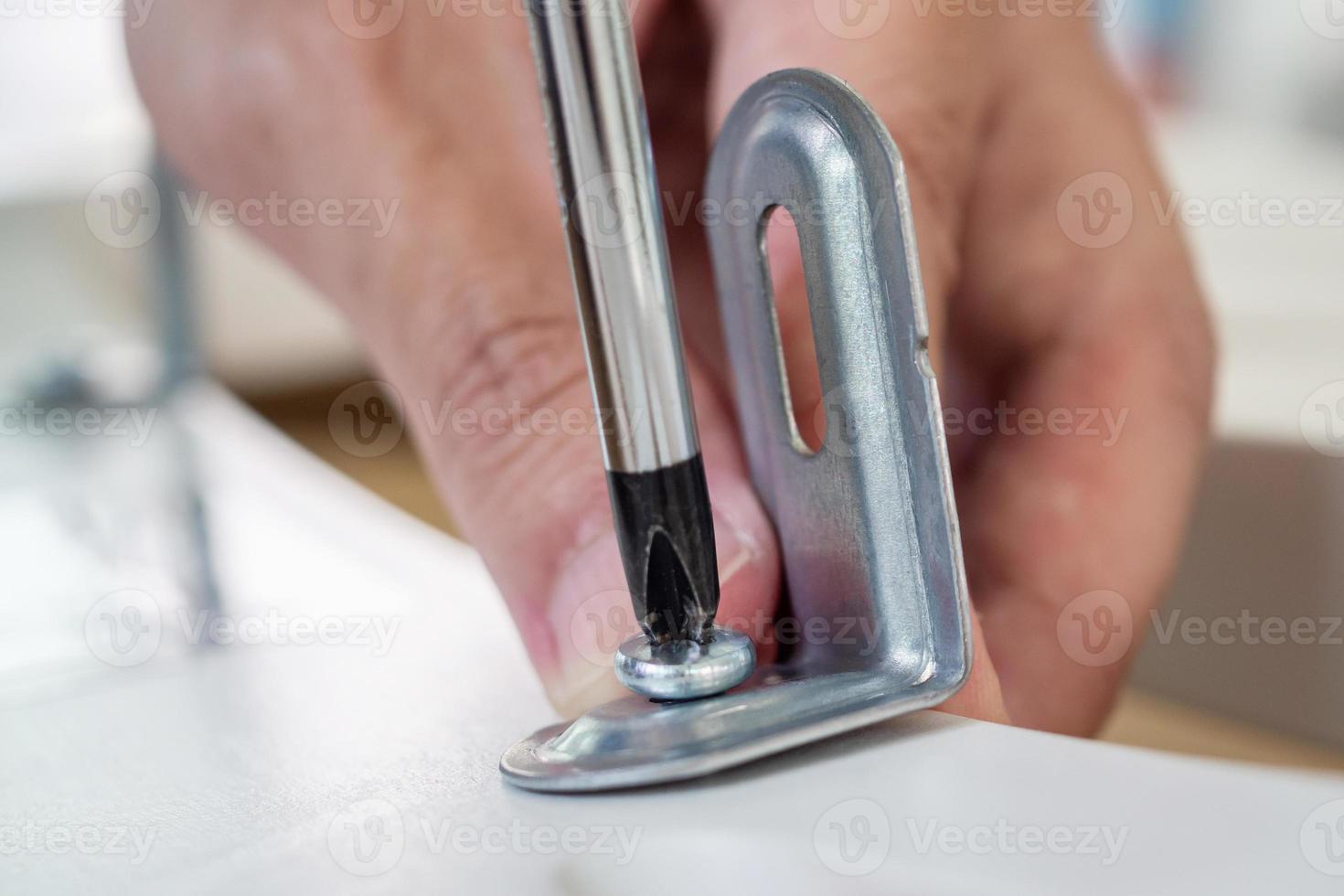 Assembly furniture using screwdriver at home photo
