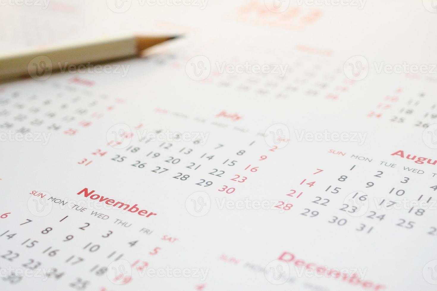 white pencil on calendar background business planning appointment meeting concept photo