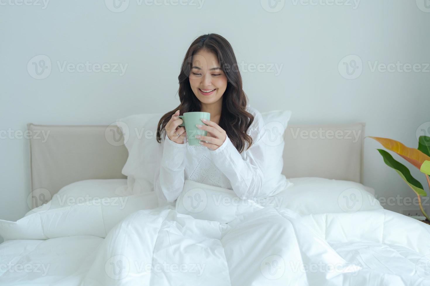 Beautiful girl sitting and drinking hot tea in the morning. photo