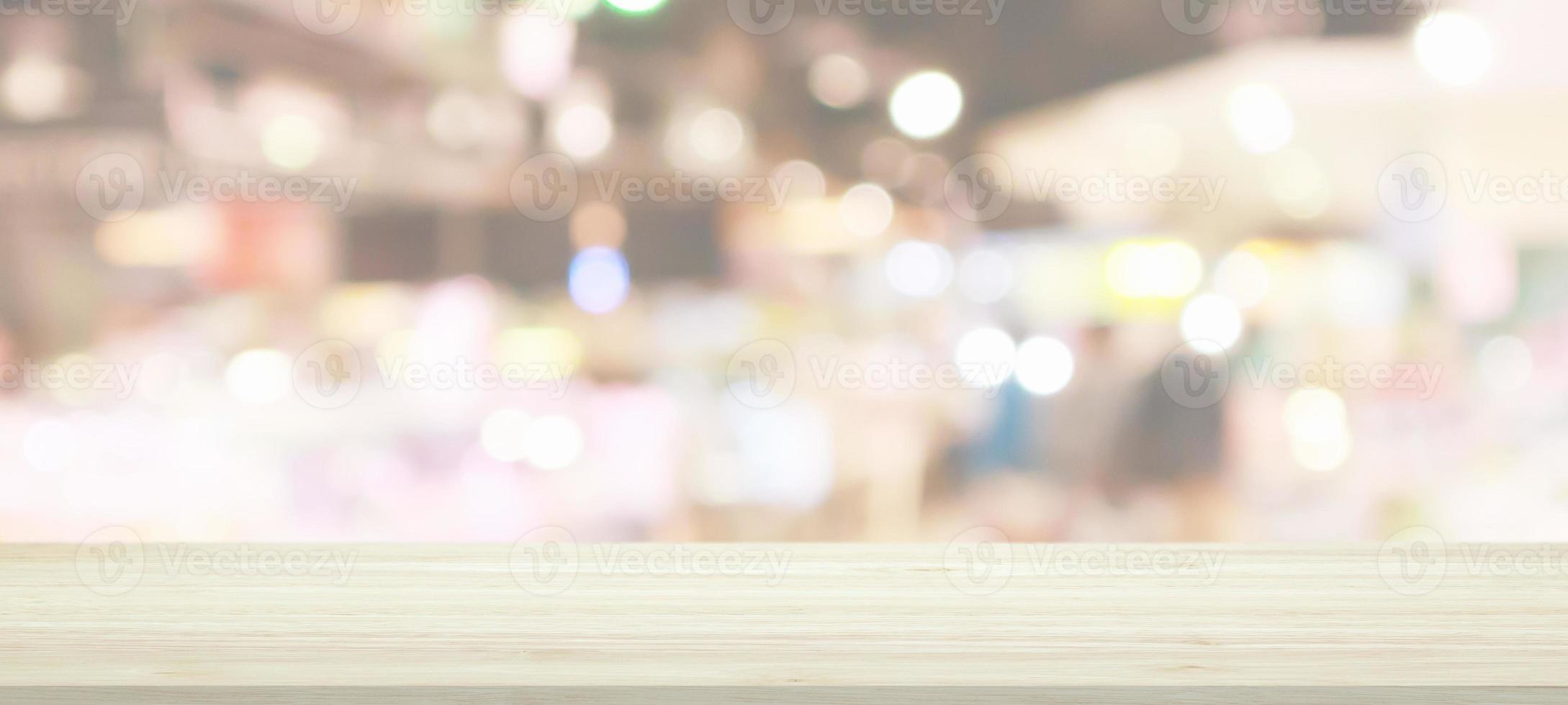 Wood table top with supermarket grocery store blurred background with bokeh light for product display photo