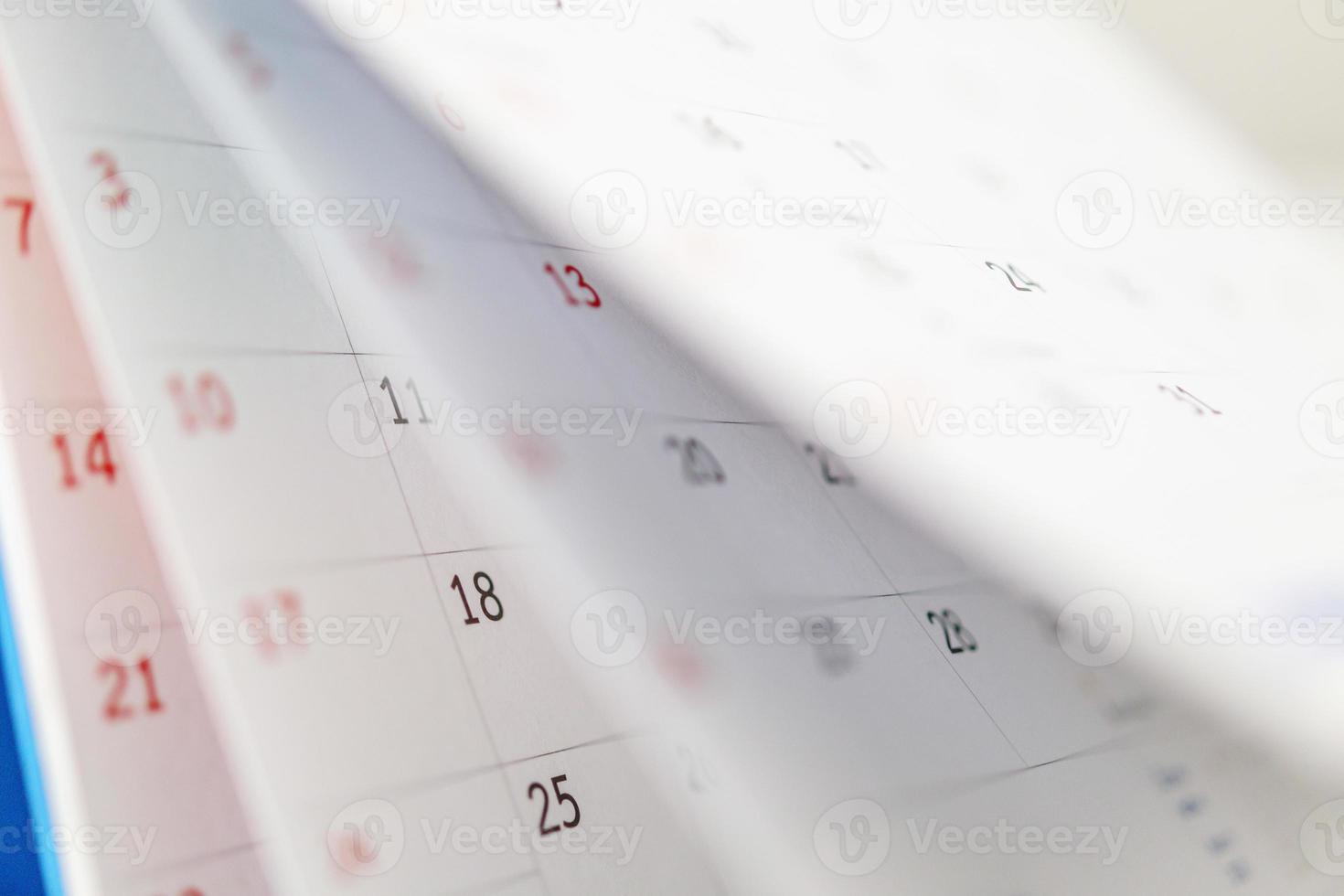 Calendar page flipping sheet close up on office table background business schedule planning appointment meeting concept photo