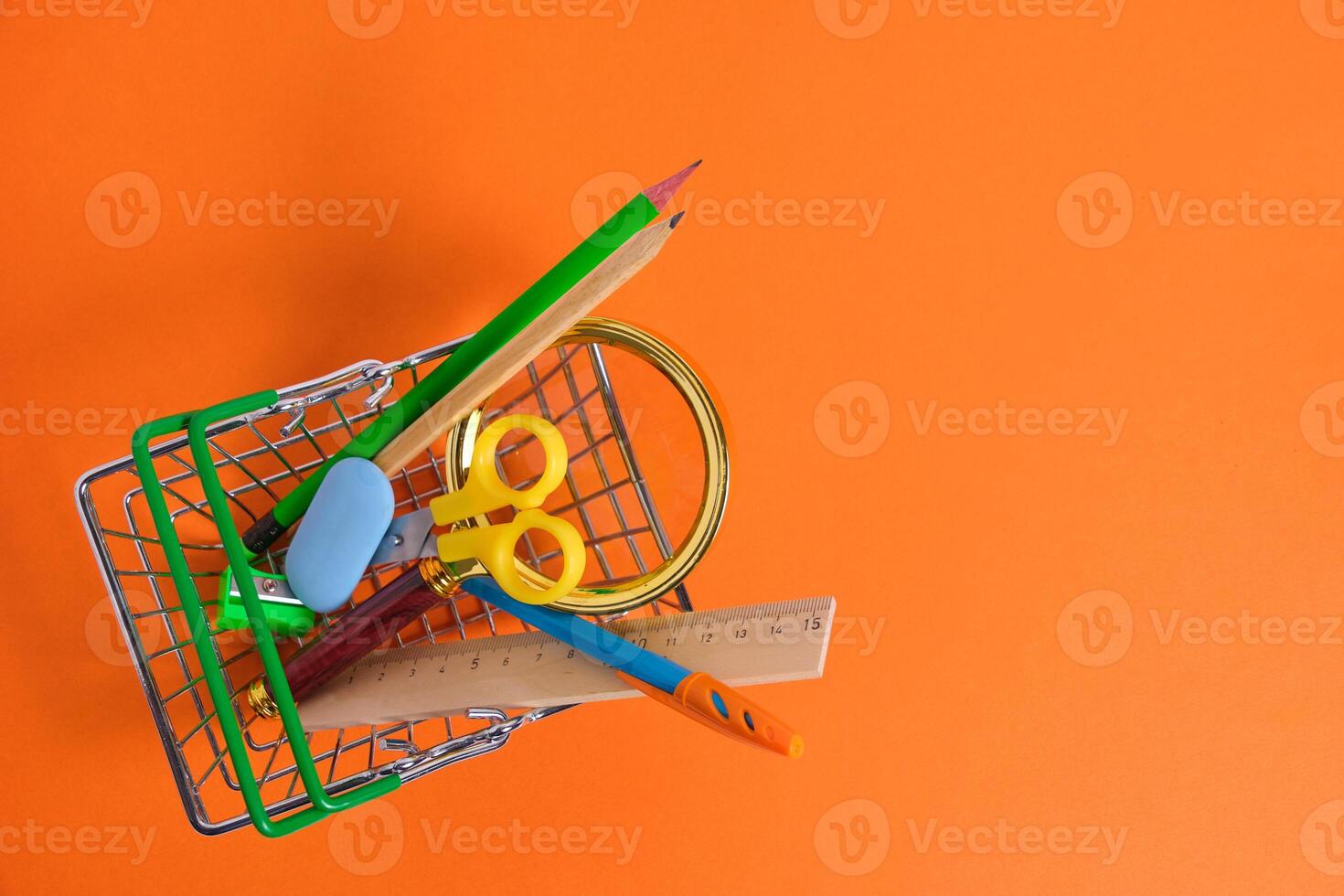 Shopping basket with office and school supplies.Concept preparing for