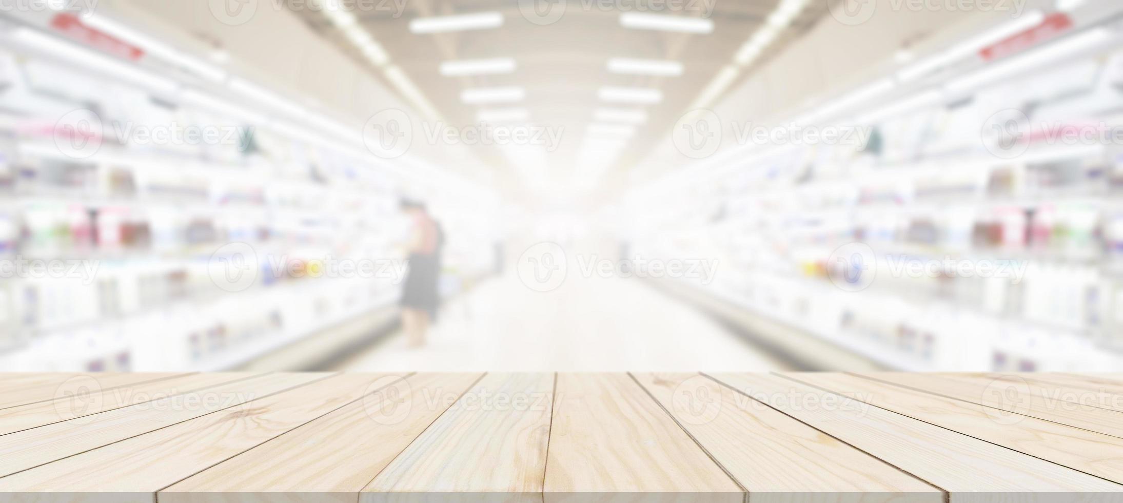 Wood table top with supermarket grocery store blurred background with bokeh light for product display photo