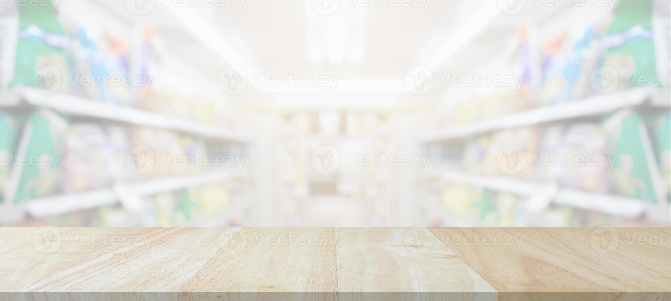 Wood table top with supermarket grocery store blurred background with bokeh light for product display photo