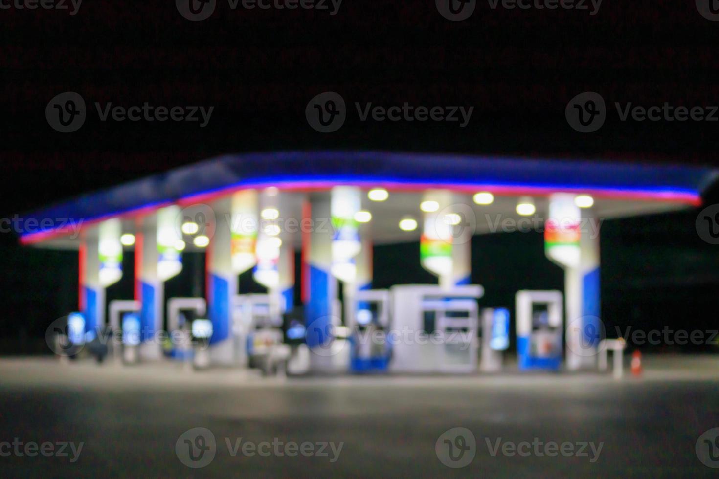 Petrol gas station at night time blurred background with bokeh light photo