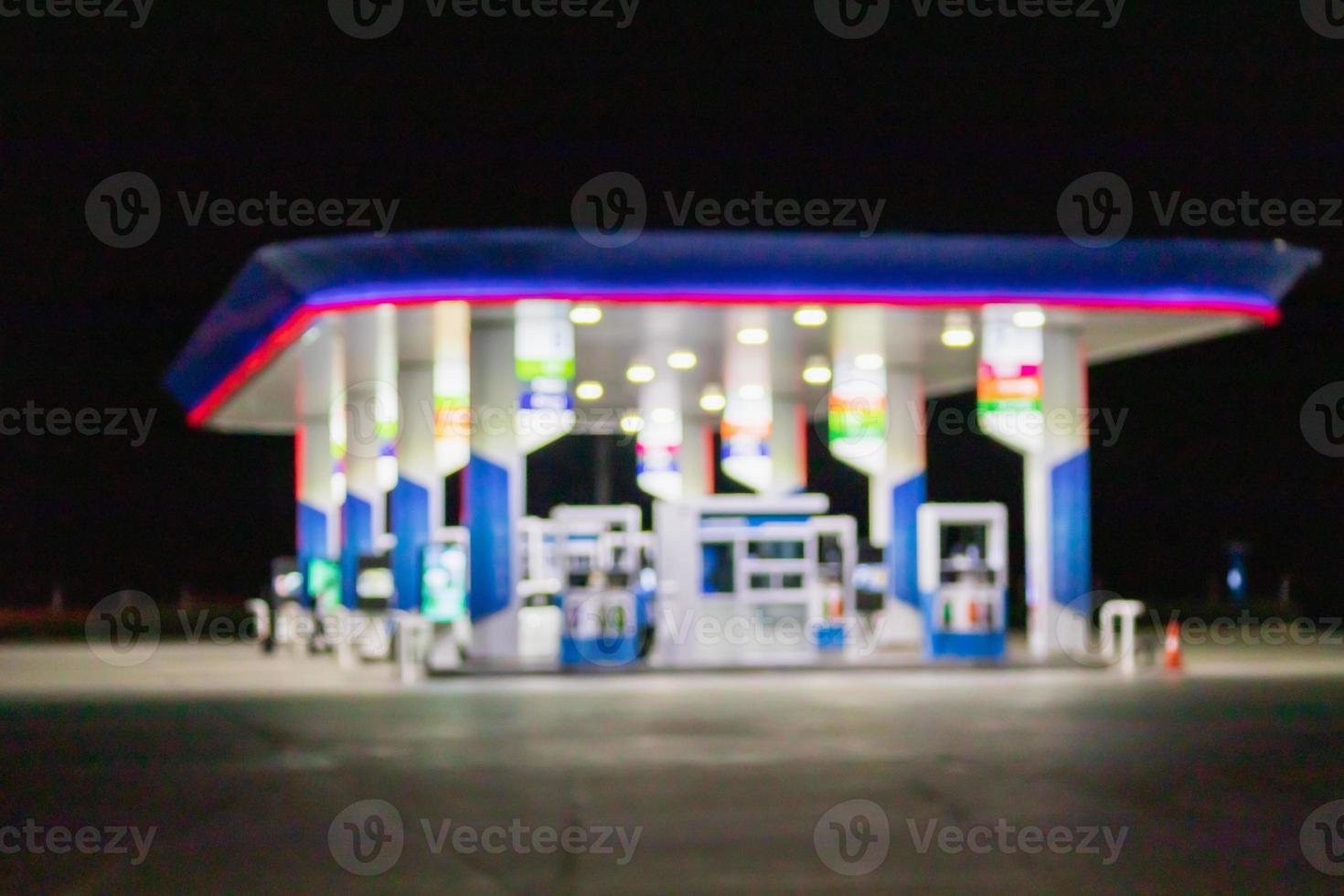 Petrol gas station at night time blurred background with bokeh light photo