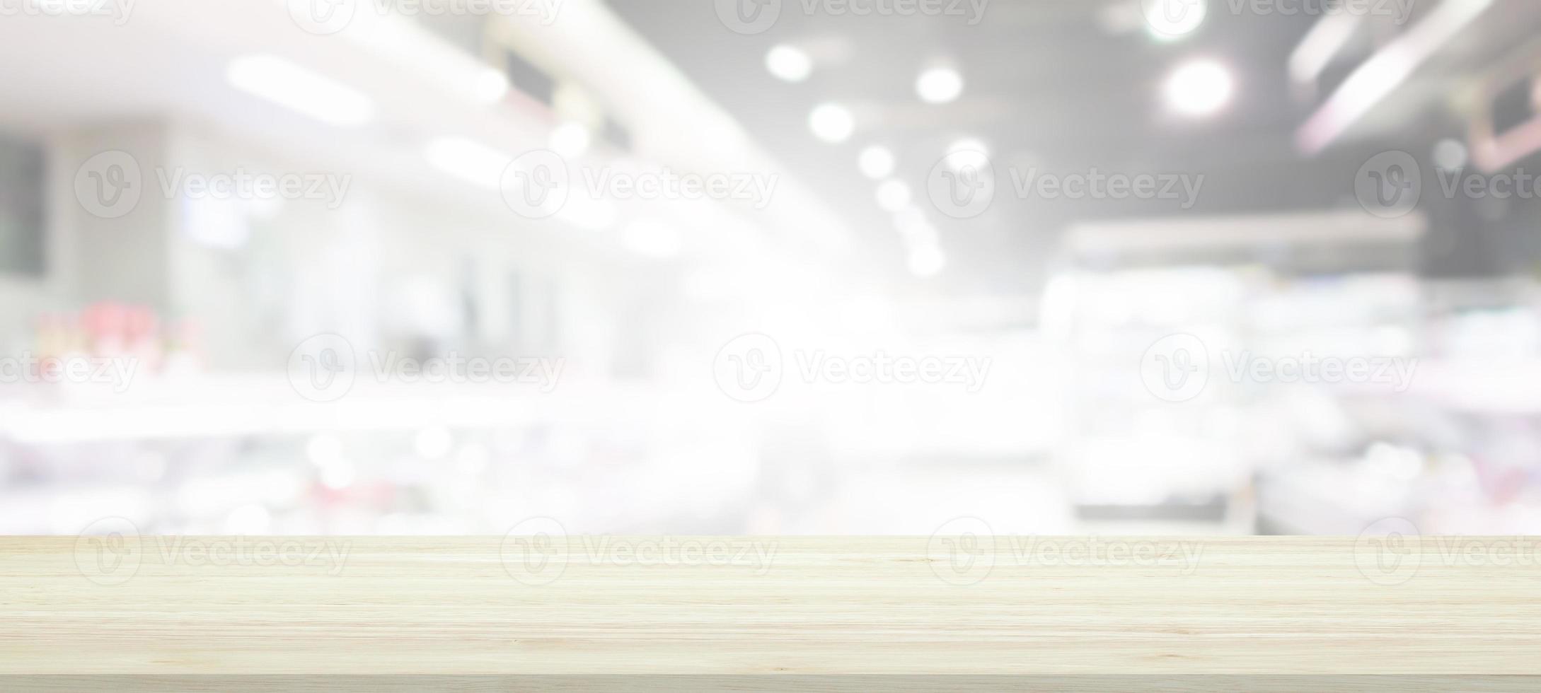 Wood table top with supermarket grocery store blurred background with bokeh light for product display photo