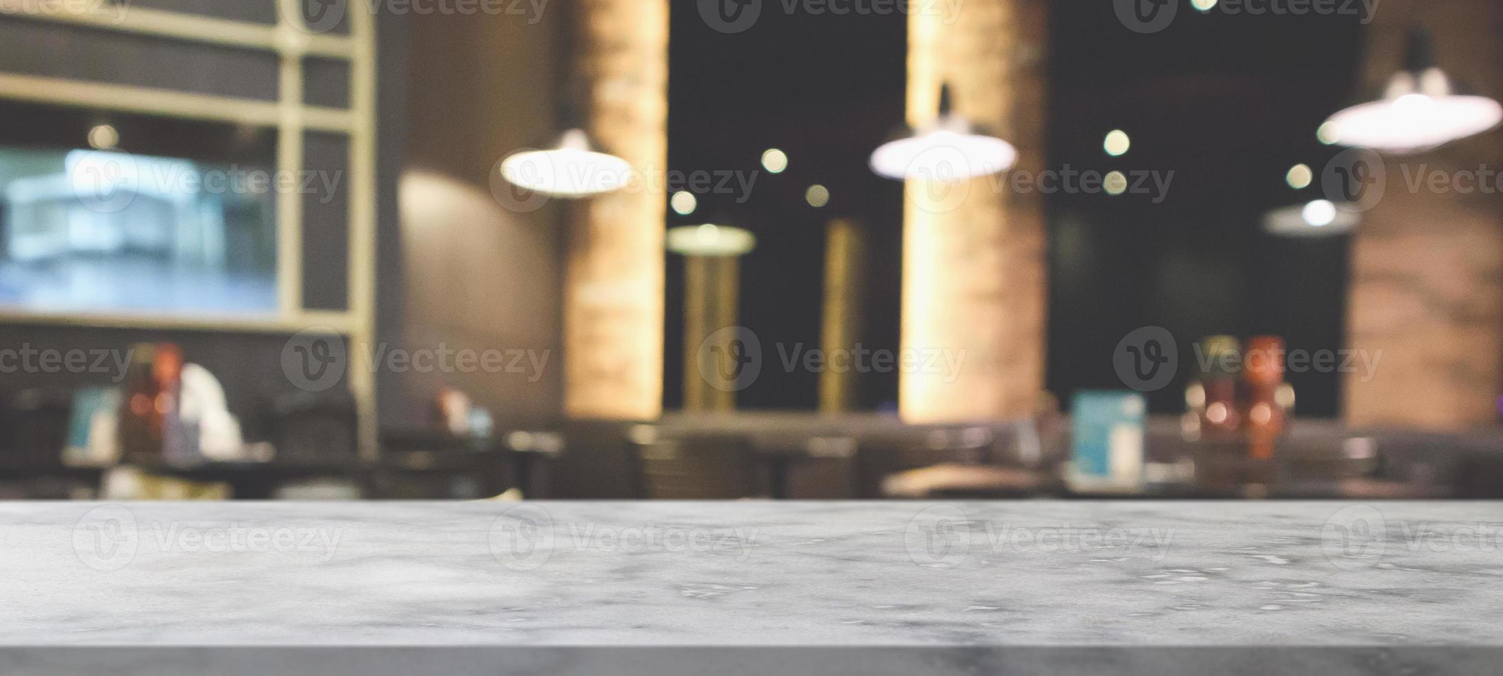 marble table top with blurred abstract cafe restaurant interior background photo