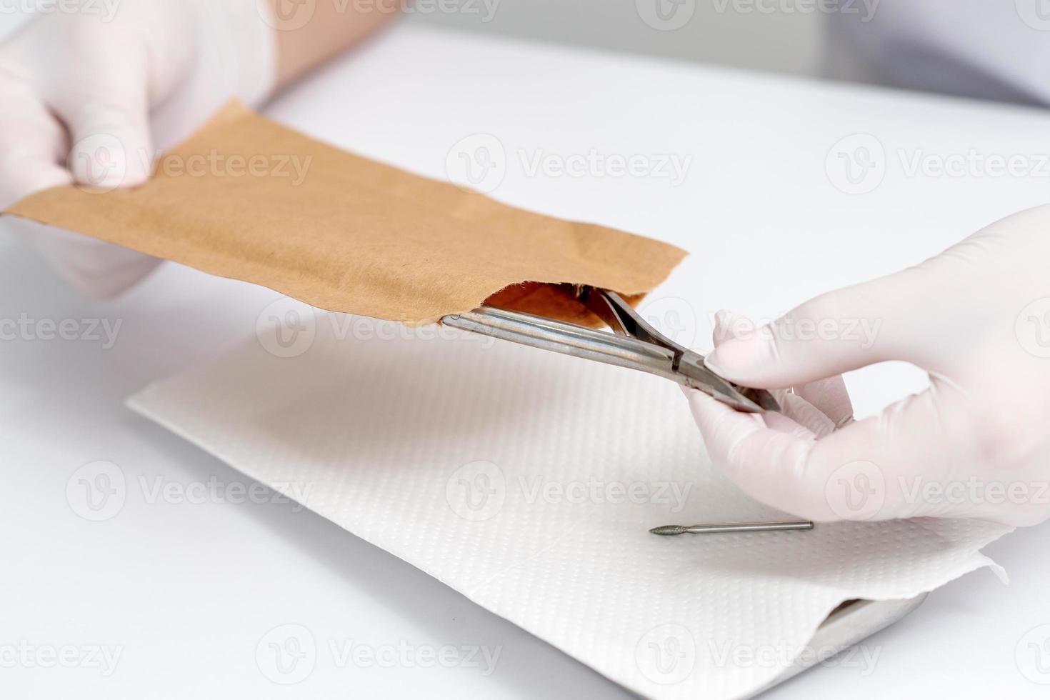 Hands taking manicure tools. photo