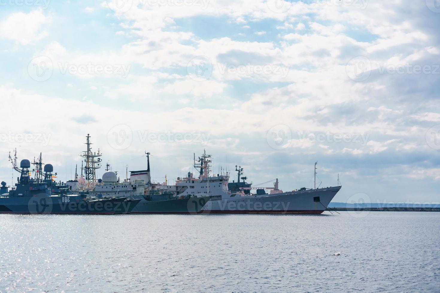 Ships of russian navy are on dock on water against background of sky photo