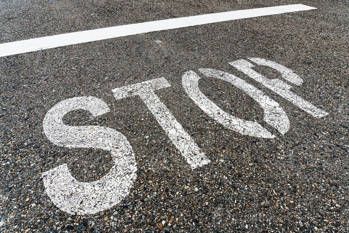 STOP sign on the road with textured asphalt. photo