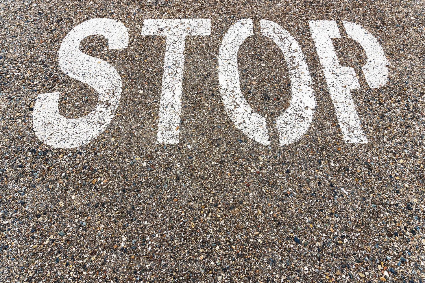 STOP a large inscription on the asphalt in full screen photo