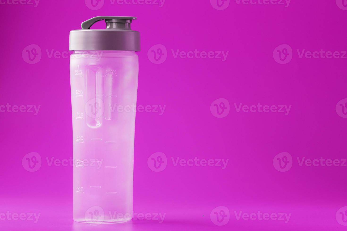 Sports smoothie bottle on pink background, empty. photo